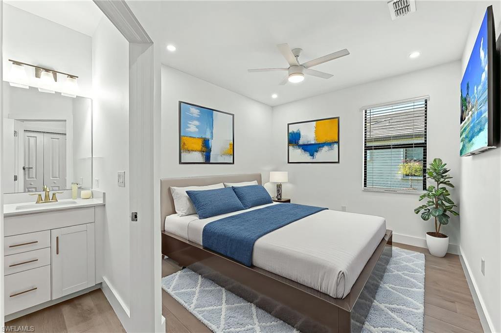 1465 Birdie Drive Naples, FL 34120 - Photo 23 of 38 a bedroom with a bed and a chandelier