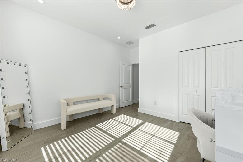 1465 Birdie Drive Naples, FL 34120 - Photo 28 of 38 a bedroom with a bed and a view of bathroom