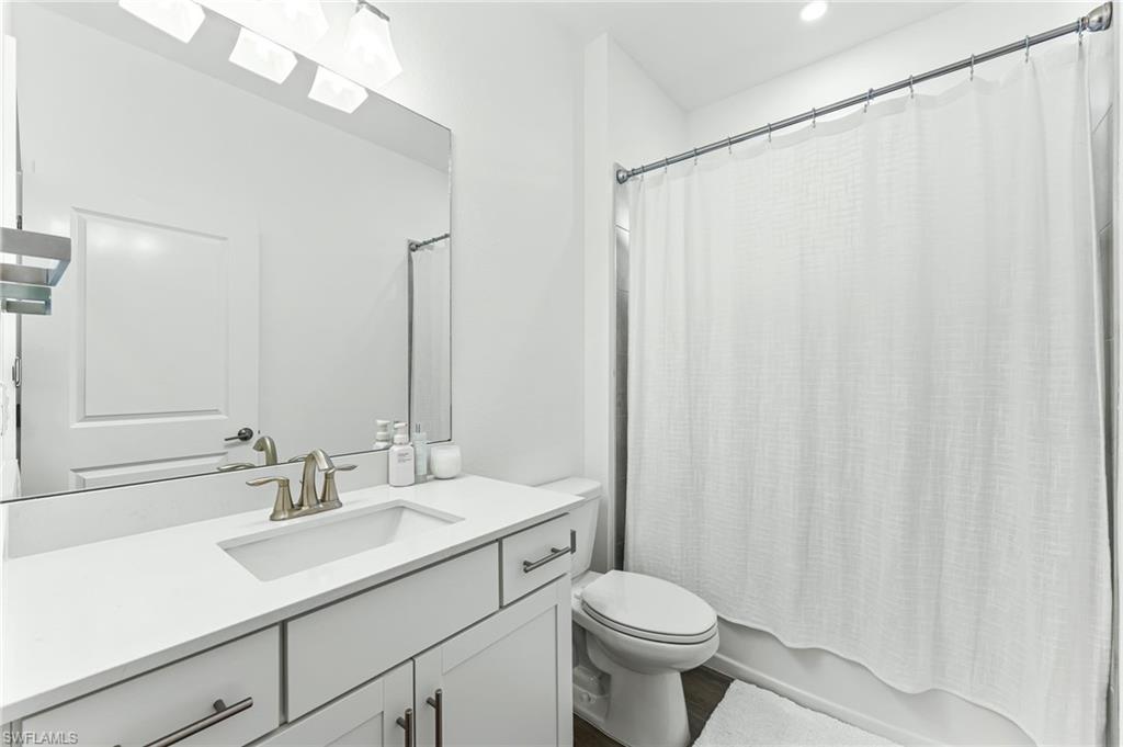 1465 Birdie Drive Naples, FL 34120 - Photo 29 of 38 a bathroom with a toilet a sink and a mirror