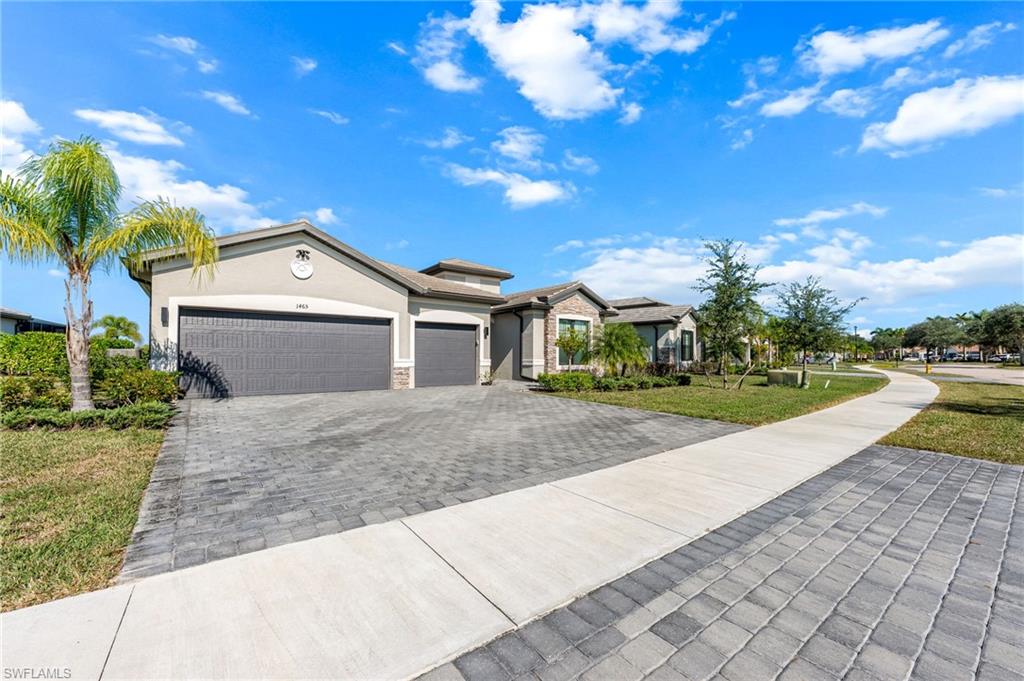 1465 Birdie Drive Naples, FL 34120 - Photo 3 of 38 a front view of a house with a yard and garage