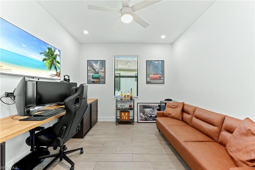 1465 Birdie Drive Naples, FL 34120 - Photo 30 of 38 a living room with furniture and a flat screen tv