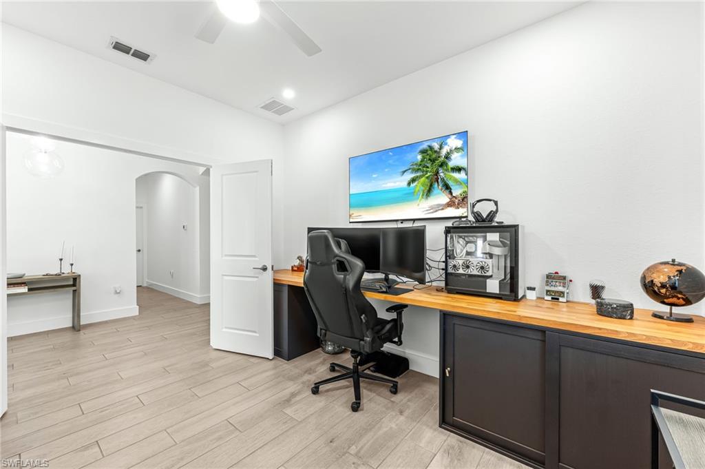 1465 Birdie Drive Naples, FL 34120 - Photo 31 of 38 a view of a workspace with furniture and wooden floor