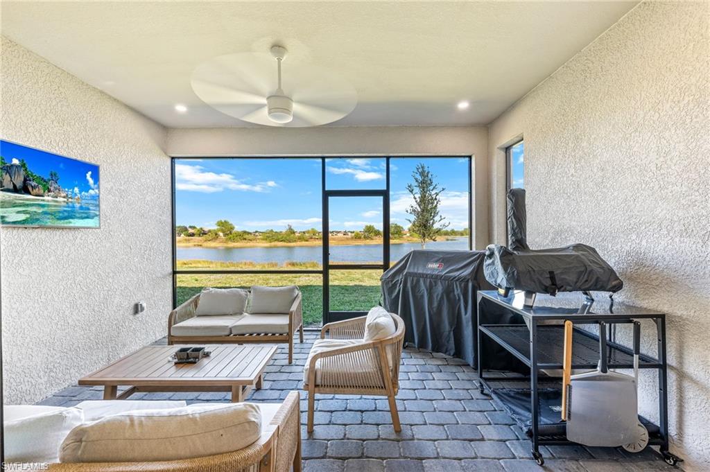 1465 Birdie Drive Naples, FL 34120 - Photo 33 of 38 a bedroom with furniture and a floor to ceiling window