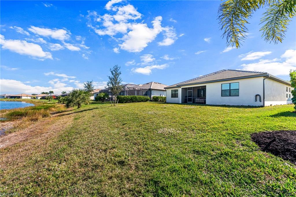 1465 Birdie Drive Naples, FL 34120 - Photo 36 of 38 a view of a house with a big yard