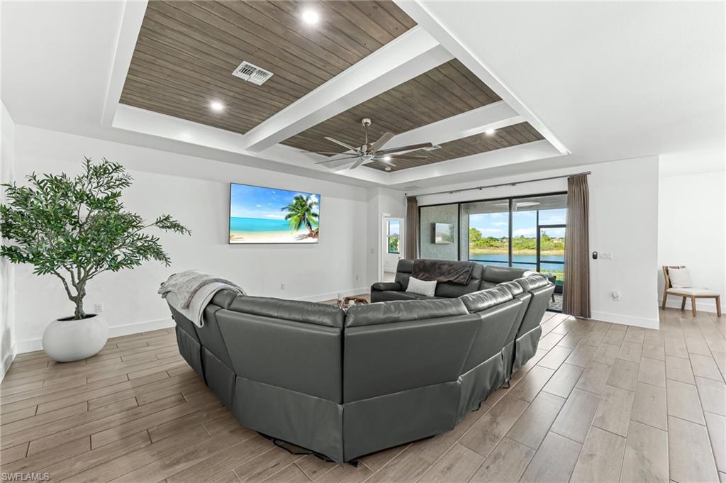 1465 Birdie Drive Naples, FL 34120 - Photo 6 of 38 a living room with furniture and potted plant