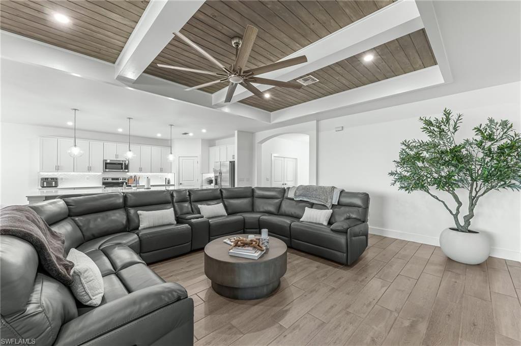 1465 Birdie Drive Naples, FL 34120 - Photo 8 of 38 a living room with furniture and a chandelier