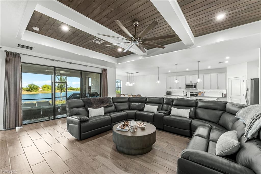 1465 Birdie Drive Naples, FL 34120 - Photo 9 of 38 a living room with furniture and a large window