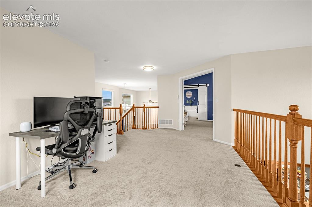 9127 Oakmont Road Peyton, CO 80831 - Photo 25 of 49 a view of a workspace with furniture and a window