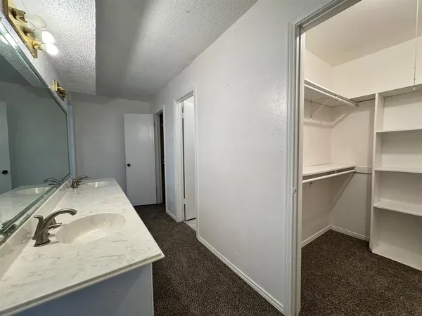 a en suite bathroom with a sink and mirror
