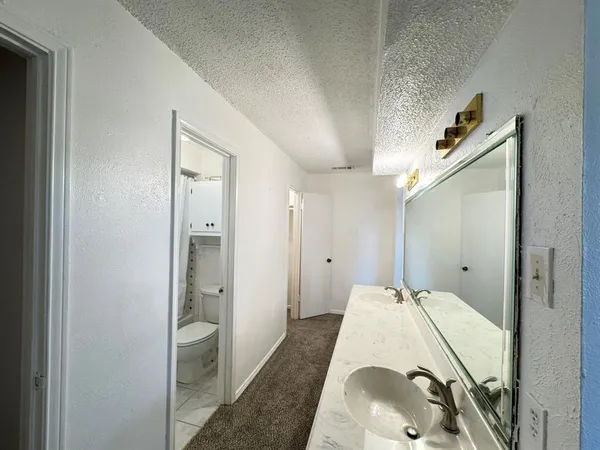 an empty room with a ceiling fan and a window