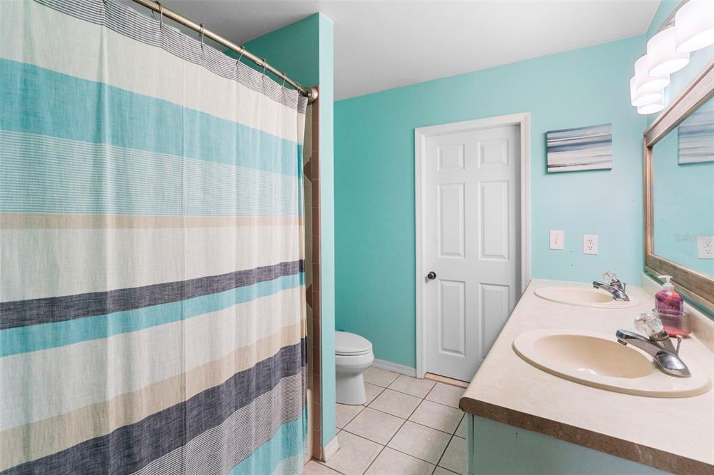 3080 Ragis Road Edgewater, FL 32132 - Photo 54 of 86 a bathroom with a sink toilet and shower