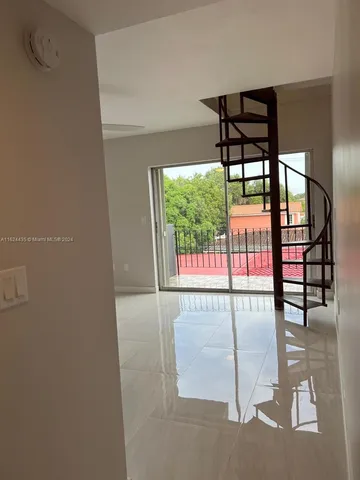 an empty room with windows and city view