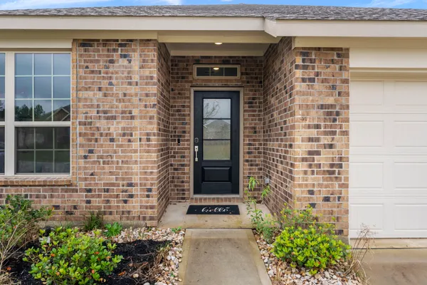 a front view of a house with potted plants