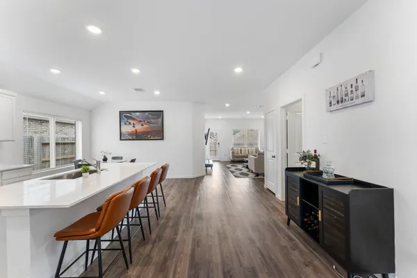 a view of a yard in front of a house with large trees