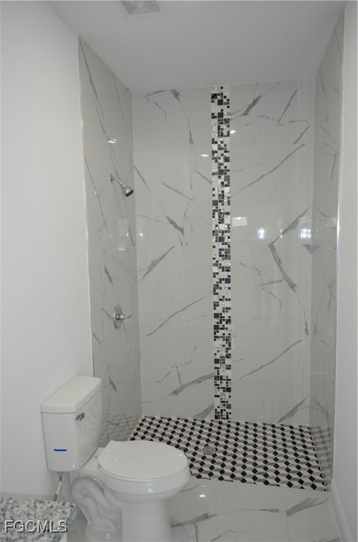 2610 34th Street West Lehigh Acres, FL 33971 - Photo 13 of 14 a bathroom with a toilet a window and a shower