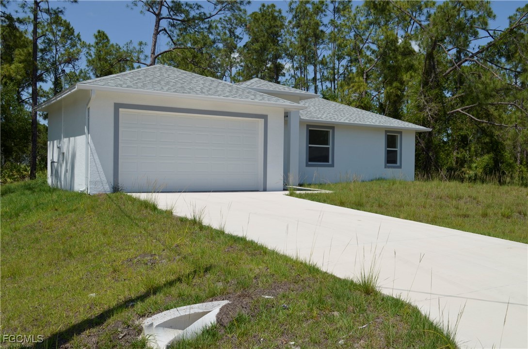 2610 34th Street West Lehigh Acres, FL 33971 - Photo 2 of 14 a house with trees in front of it
