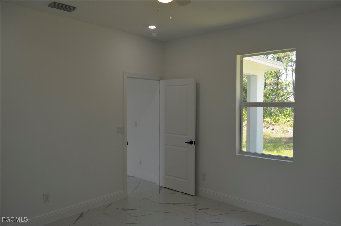2610 34th Street West Lehigh Acres, FL 33971 - Photo 5 of 14 a view of an empty room with a window