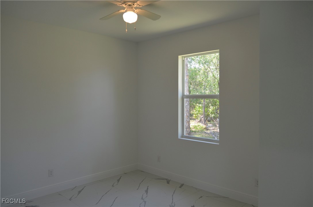 2610 34th Street West Lehigh Acres, FL 33971 - Photo 9 of 14 an empty room with windows