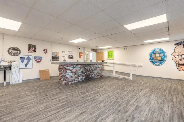 a room with lots of wooden furniture and window