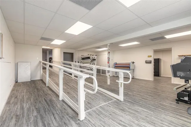 a view of a kitchen with furniture and wooden floor