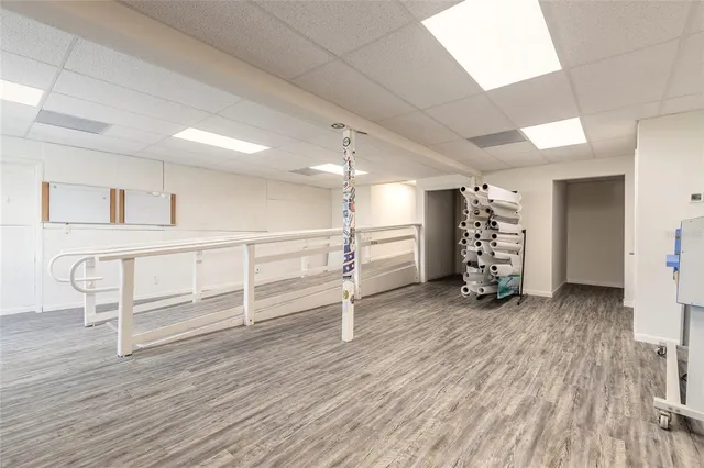 a view of a room with wooden floor and windows