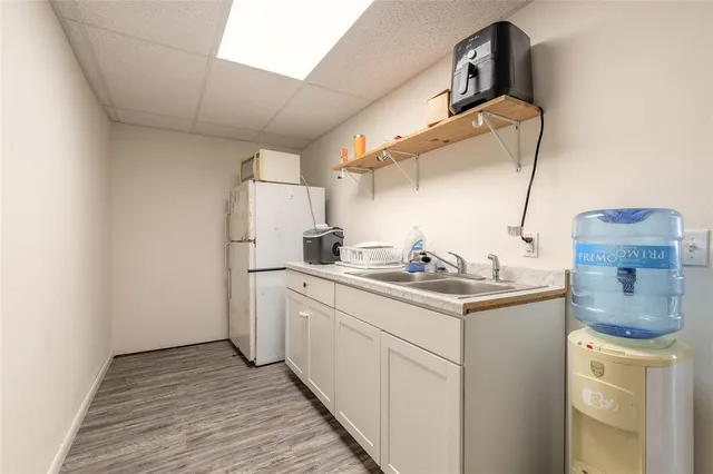 a kitchen with a sink cabinets and appliances