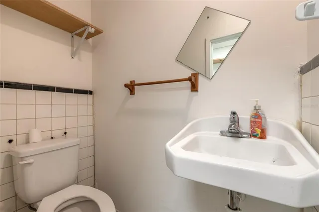 a bathroom with a sink mirror vanity and toilet