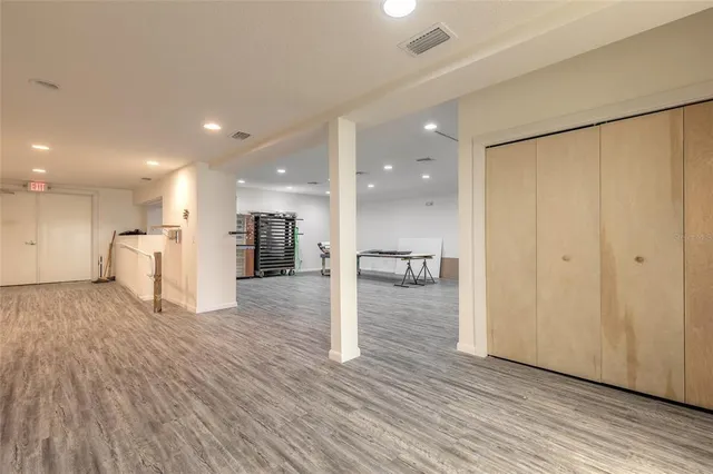 a view of a big room with wooden floor windows and a kitchen view