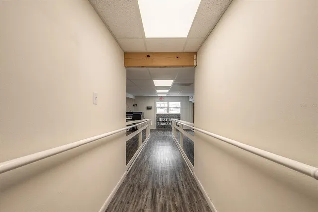 a view of a hallway with wooden floor
