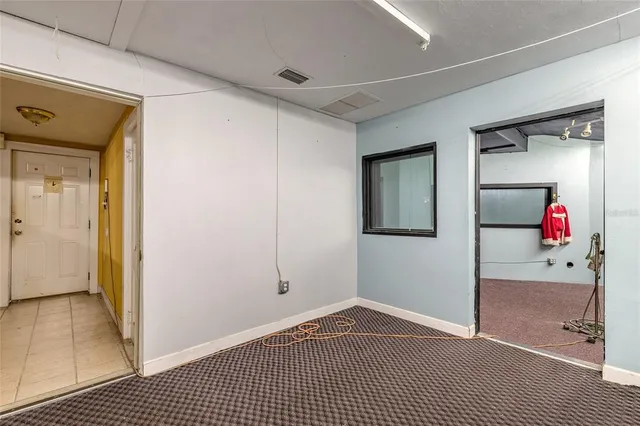 en empty room with a projector and fan