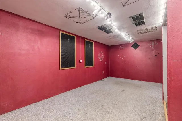 a view of a hallway with a projector and furniture