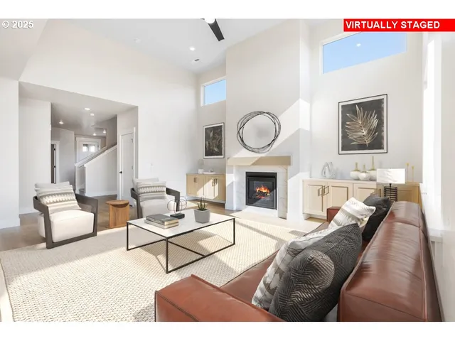 a living room with furniture a fireplace and a large mirror