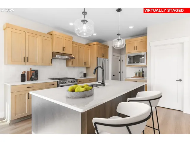 a kitchen with a dining table chairs and white cabinets
