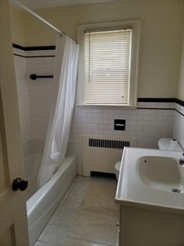 110 Clay Street, Unit 4 Quincy, MA 02170 - Photo 5 of 7 a bathroom with a bathtub and a window