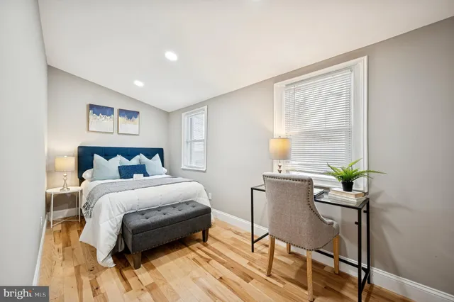 a bed room with a bed window and a chair