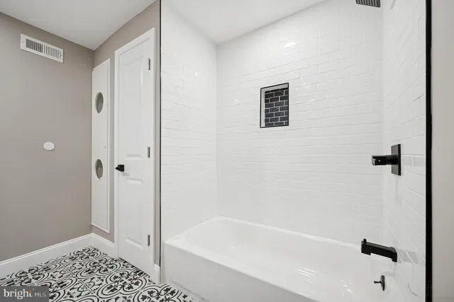 a bathroom with a bathtub and shower