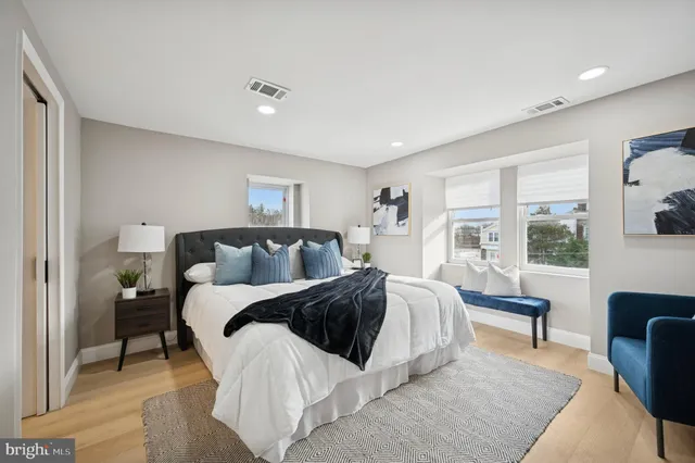 a spacious bedroom with a bed and a couch