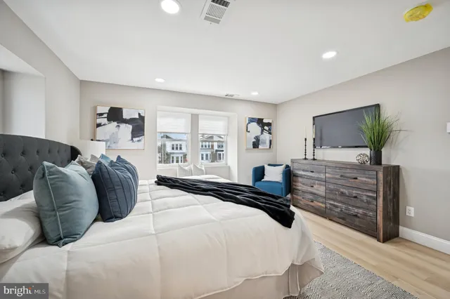 a bedroom with a bed and a flat screen television