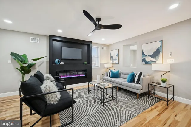 a living room with furniture a rug and a fireplace