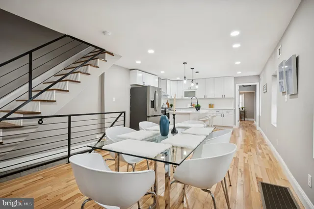 a dining room with furniture and a kitchen view