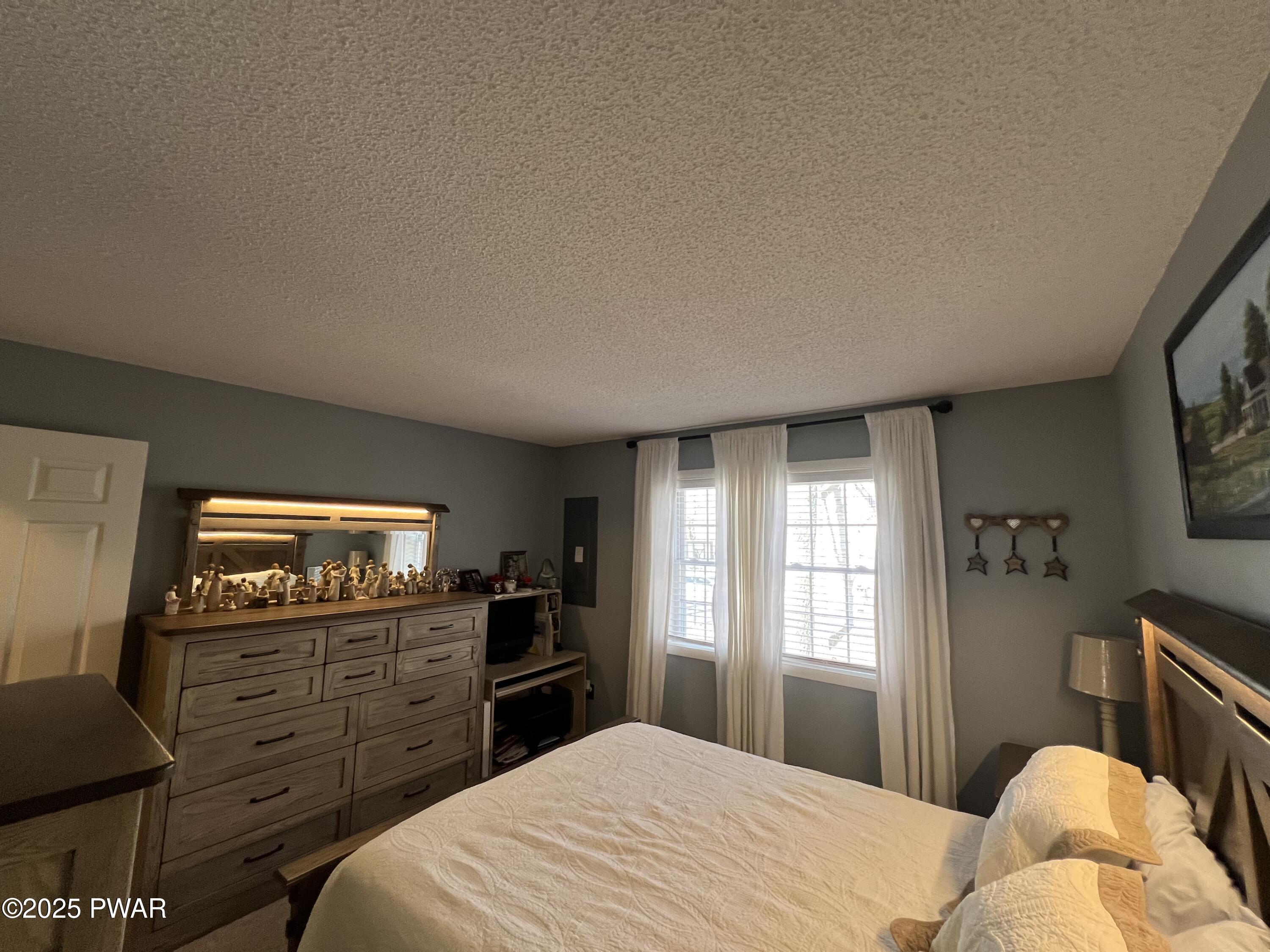 119 Rodeo Drive Hawley, PA 18428 - Photo 20 of 34 a bedroom with a bed and a flat screen tv