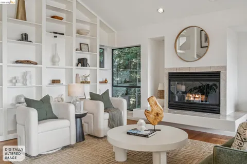 a living room with furniture a fireplace and a large window