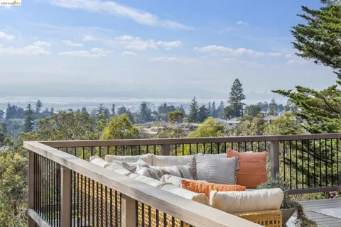 a dining room with furniture a potted plant and a chandelier