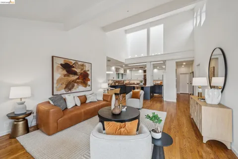 a bathroom with a granite countertop sink mirror vanity bathtub and a toilet