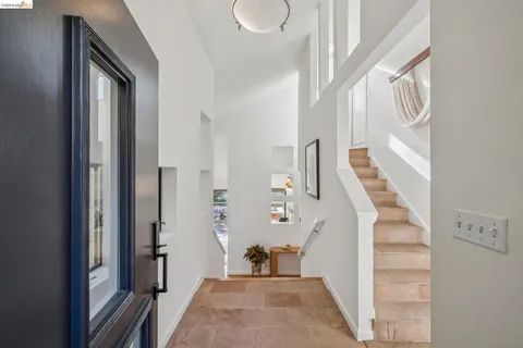 a living room with fireplace furniture and a large window