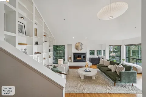 a living room with furniture a fireplace and a large window