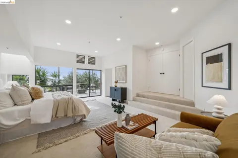 a view of a balcony with chairs and wooden floor