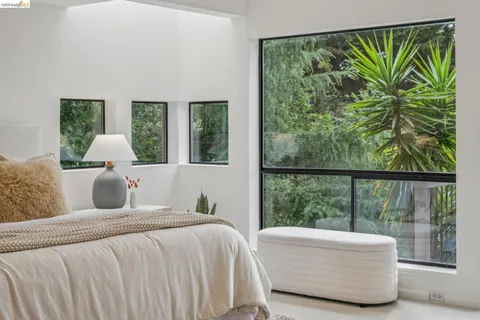 a bedroom with a bed and a potted plant