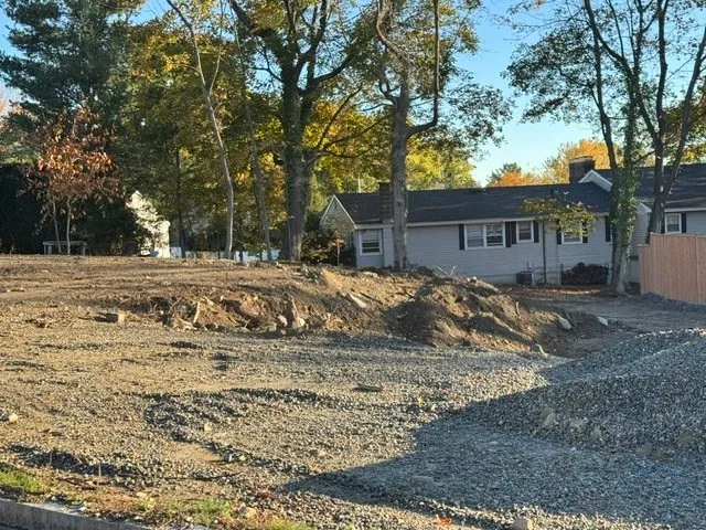 a view of a house with a yard covered in snow