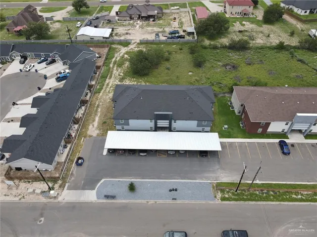 an aerial view of residential houses with outdoor space